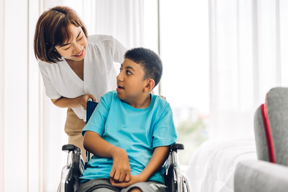 nurse with a disabled young boy on wheelchair