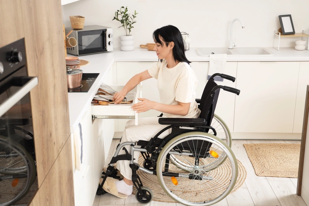 women cooking food in her specially designed kitchen catering her disabilities assistance design